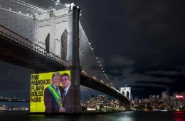 Protesto em Nova York projeta Flávio Bolsonaro entregando faixa presidencial a Trump