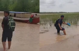 Estudantes empurram barcos na lama para conseguir chegar à escola durante seca no Amapá