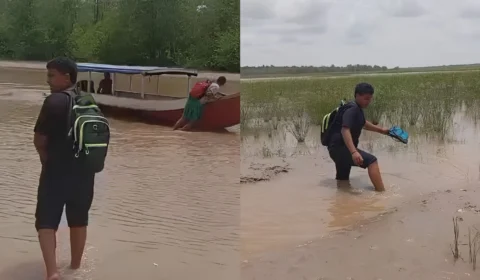 Estudantes empurram barcos na lama para conseguir chegar à escola durante seca no Amapá