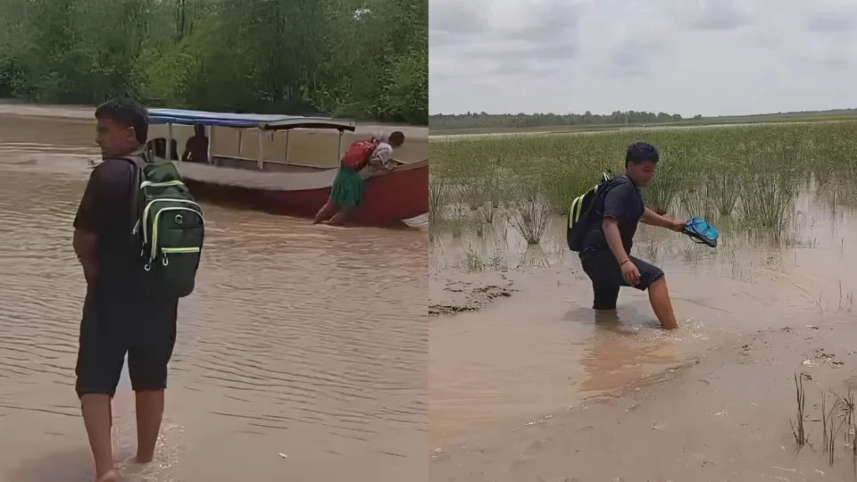 Estudantes empurram barcos na lama para conseguir chegar à escola durante seca no Amapá