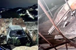 Carro bate em muro e fica pendurado sobre telhado de casa na Grande BH